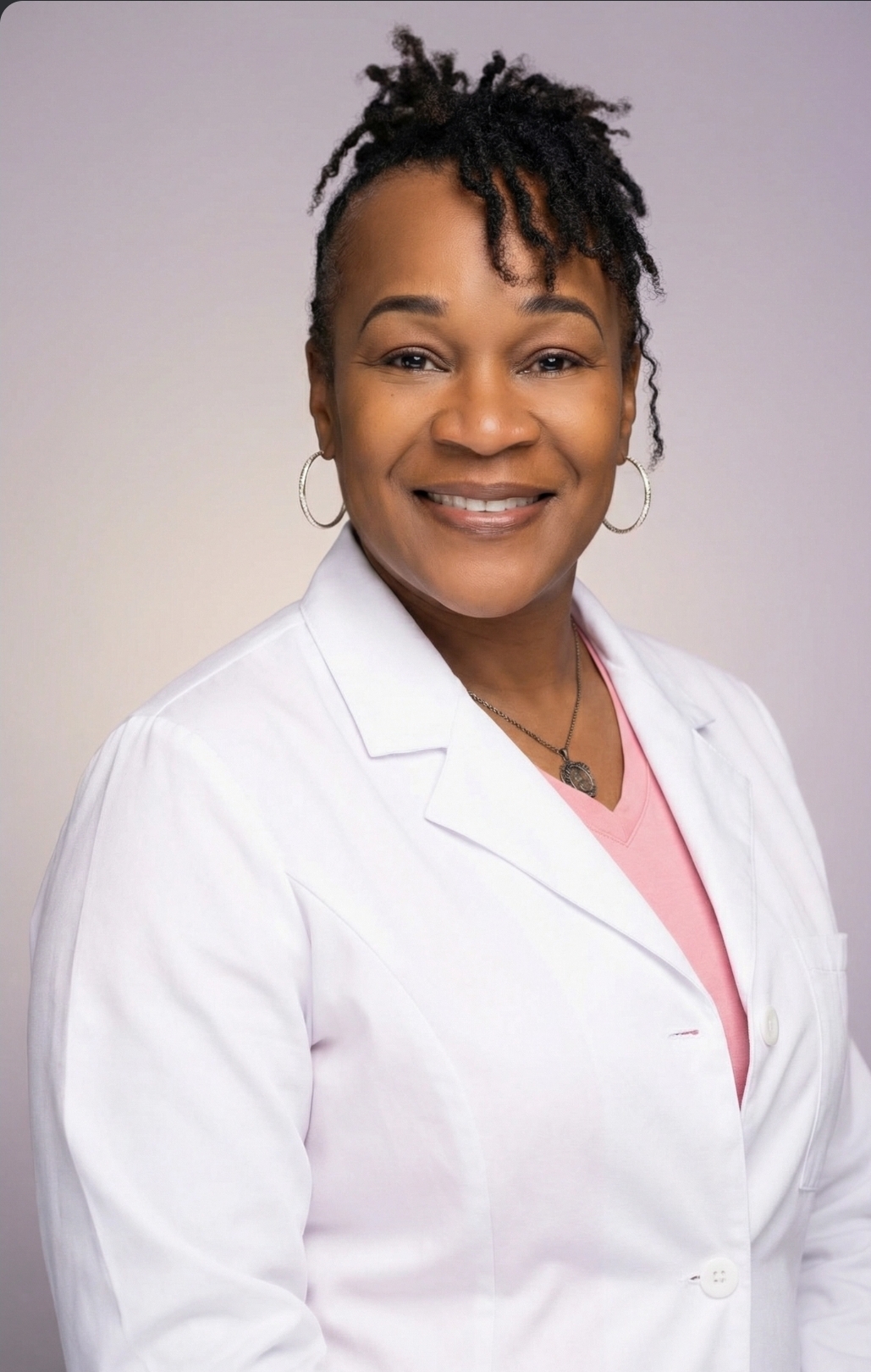 Angel Williams-Kent, APRN, FNP-C, provider at Wellness & Balance LLC, wearing a white clinical coat